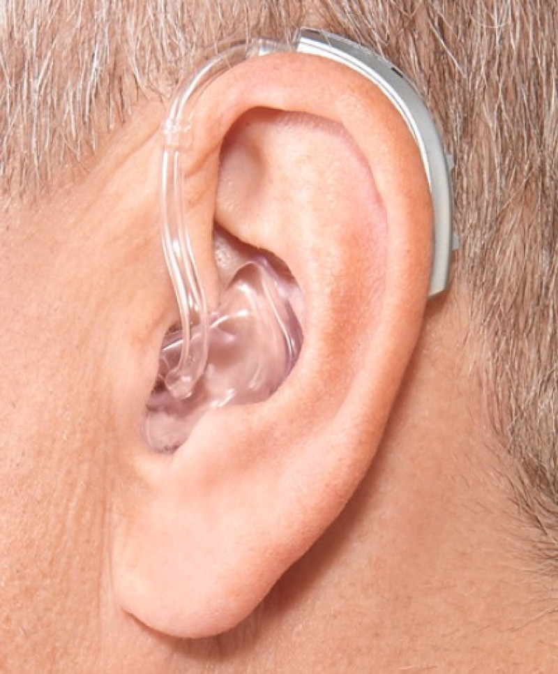 BTE hearing aid worn behind the ear with custom earmold and comfortable fit
